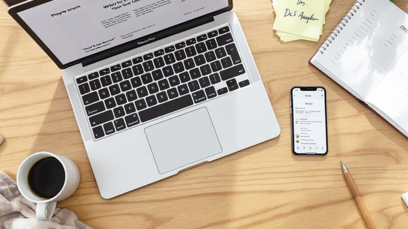 Professional website design workspace with laptop, coffee and planning notes - KM Digital Solutions